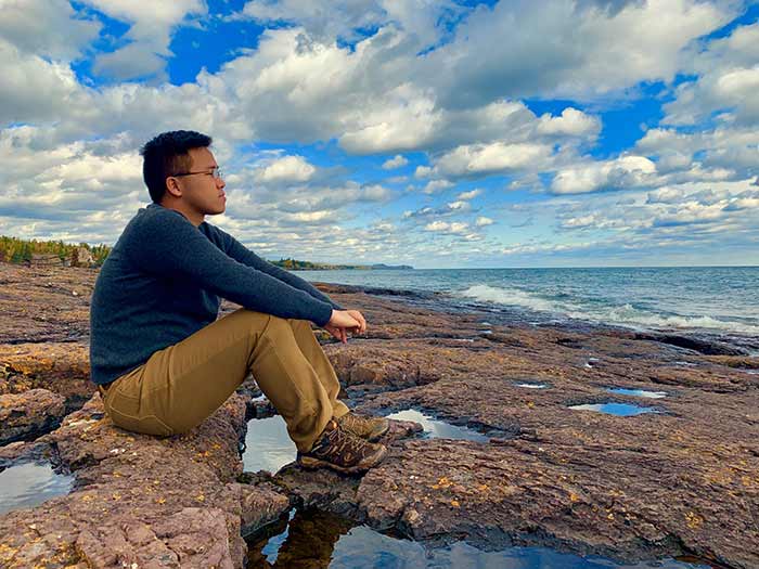 A man sitting calming by a lake
