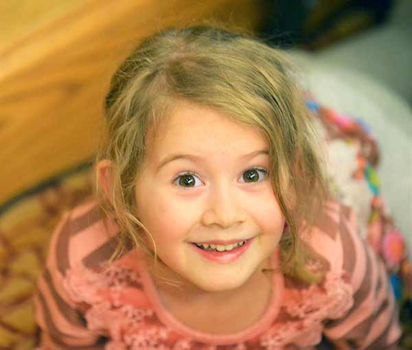 A close up of a child smiling