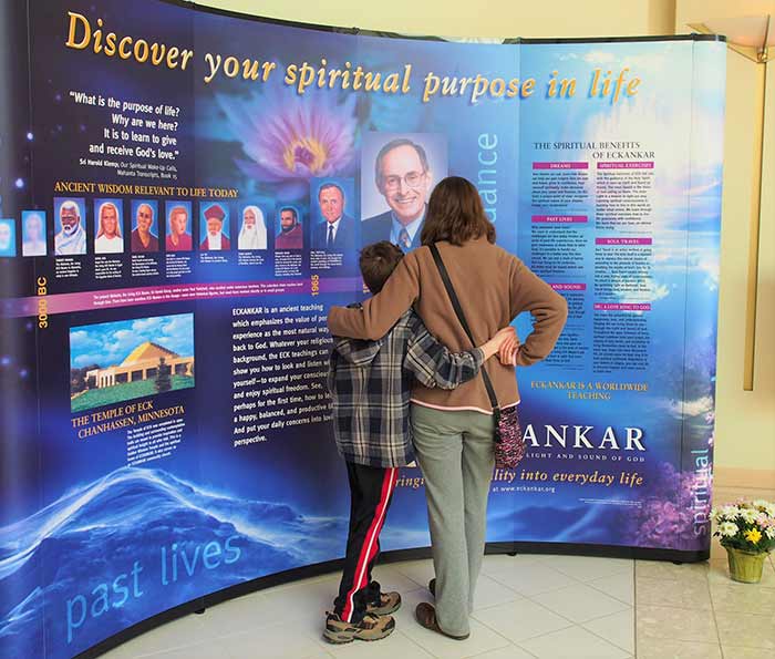 A mother and child looking at an Eckankar display together