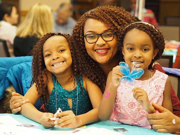 A mother smiling with her two children